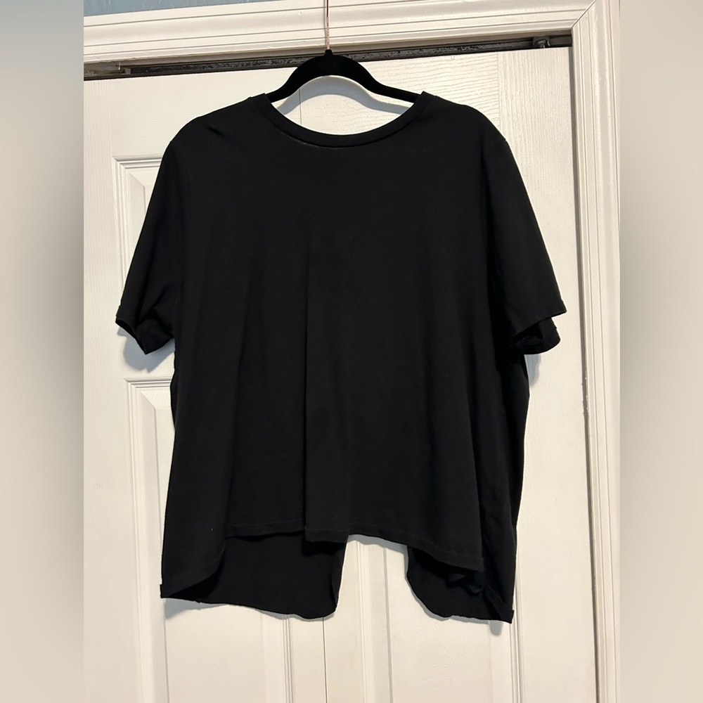 Black short sleeve split back top.
